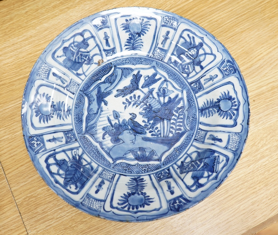 A 17th century Chinese blue and white ‘Kraak’ ware dish together with a Japanese celadon ground ‘dodo’ dish, initialled SGR, 33cm. Condition - fair